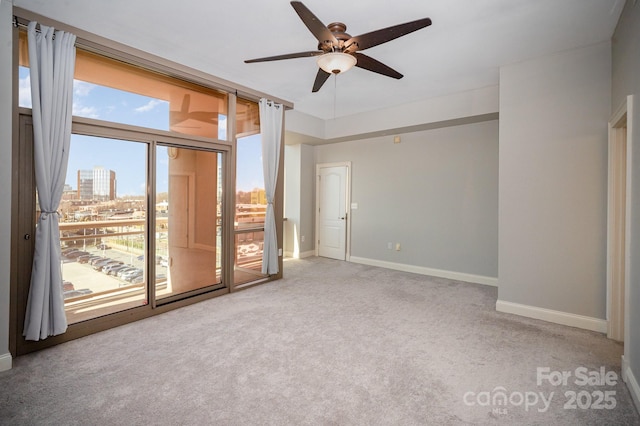 carpeted empty room featuring ceiling fan