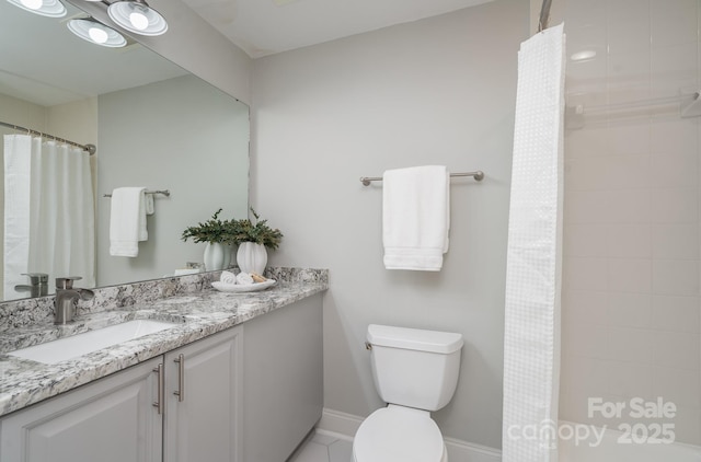 bathroom featuring vanity, toilet, and curtained shower