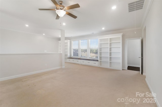 unfurnished living room featuring crown molding, light colored carpet, and ceiling fan