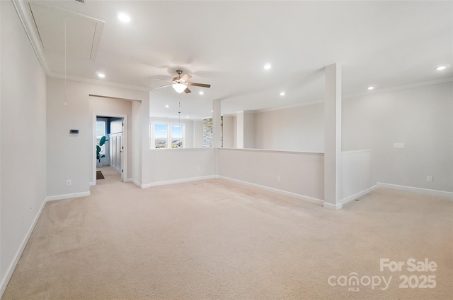 empty room with ceiling fan, light colored carpet, and ornamental molding