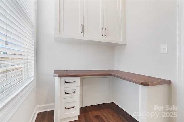 unfurnished office with dark wood-type flooring