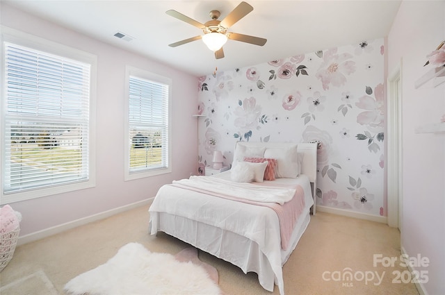 bedroom featuring light carpet and ceiling fan