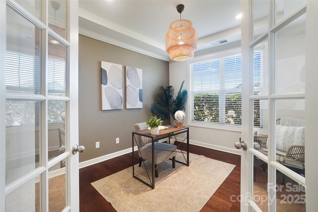 office with dark hardwood / wood-style floors and french doors