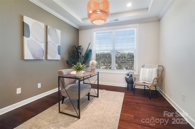 office area with dark hardwood / wood-style flooring, ornamental molding, and a raised ceiling