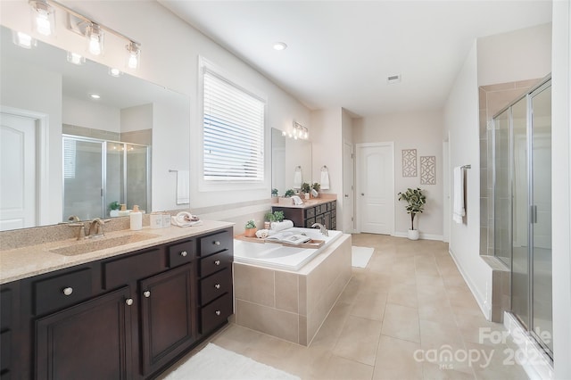 bathroom with tile patterned flooring, vanity, and shower with separate bathtub