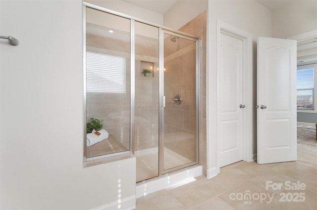 bathroom featuring tile patterned floors and a shower with shower door