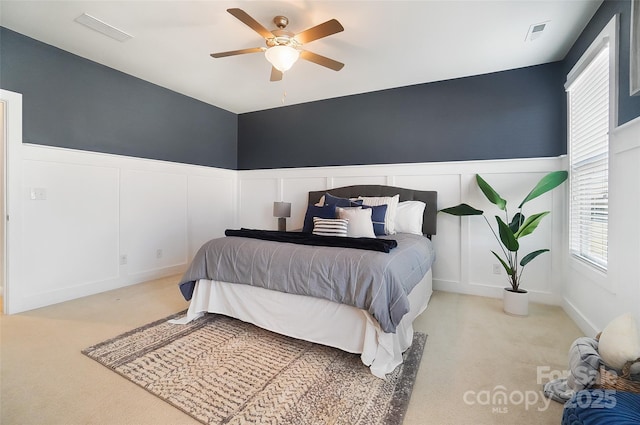 bedroom with ceiling fan and light carpet