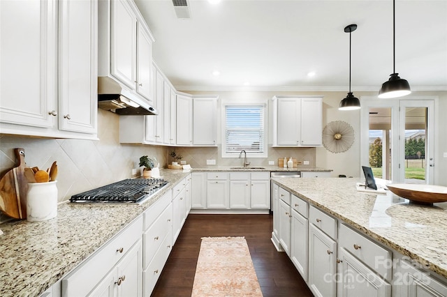 kitchen featuring white cabinetry, decorative light fixtures, dark hardwood / wood-style flooring, and light stone counters