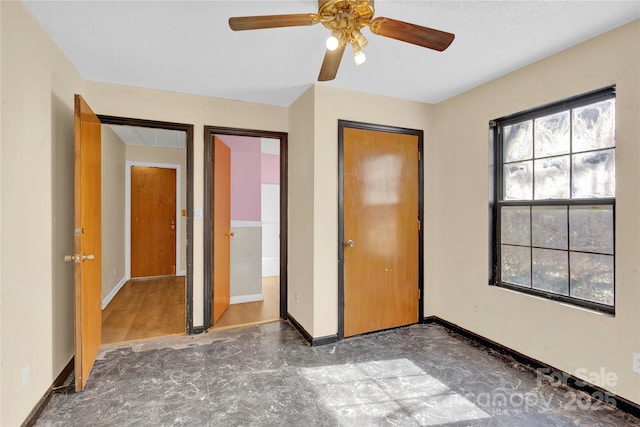 unfurnished bedroom with ceiling fan and a closet