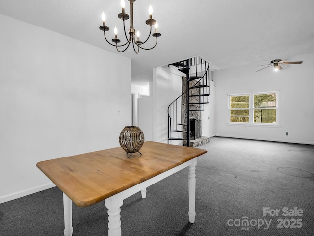 unfurnished dining area with carpet floors and ceiling fan with notable chandelier