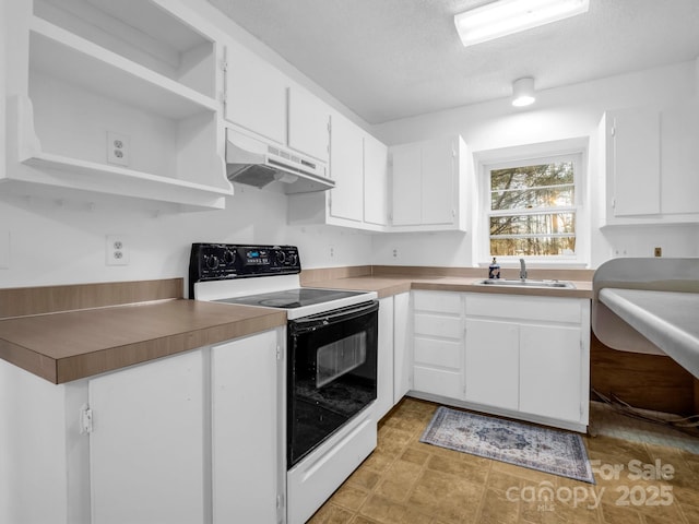 kitchen with white cabinets, sink, and electric range