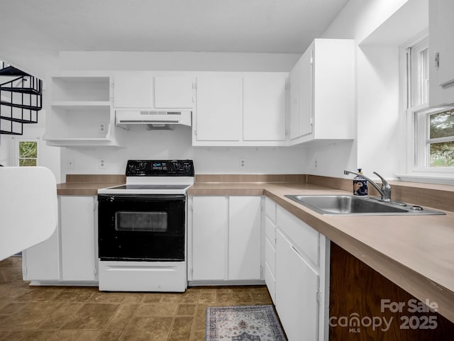 kitchen with range with electric cooktop, sink, and white cabinets