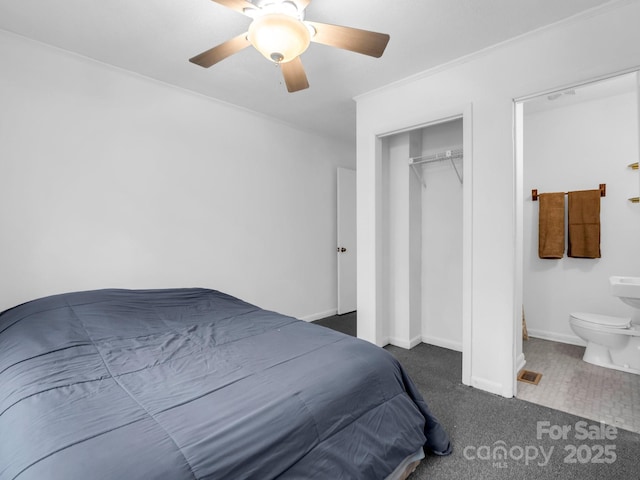 carpeted bedroom featuring crown molding, ceiling fan, ensuite bathroom, and a closet