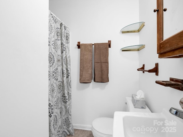 bathroom featuring sink and toilet