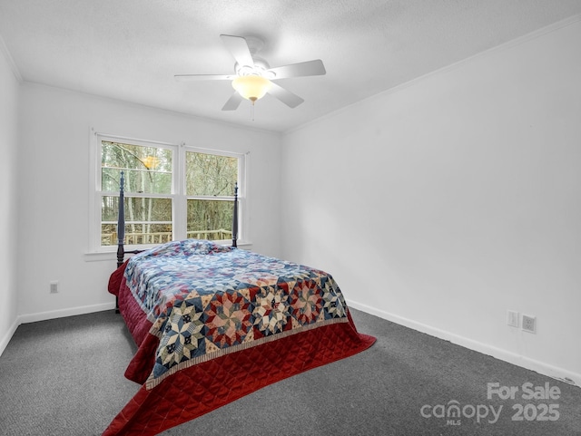 bedroom featuring dark carpet, ornamental molding, and ceiling fan