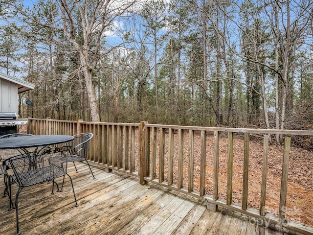 wooden terrace featuring a grill