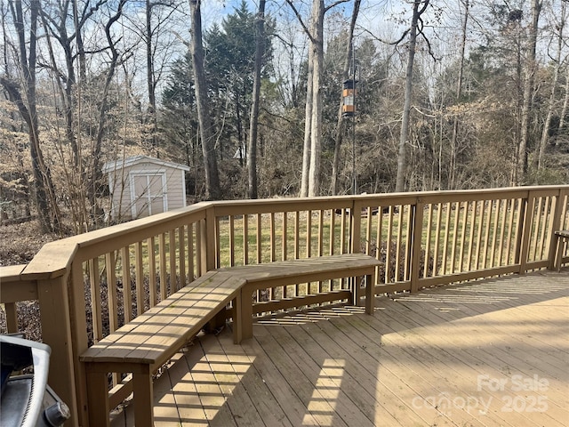 wooden deck featuring an outbuilding and a storage shed