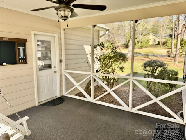 view of exterior entry featuring ceiling fan