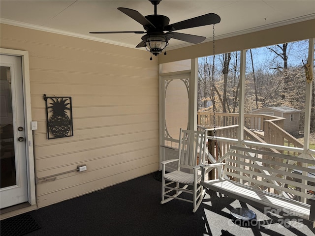 unfurnished sunroom with ceiling fan