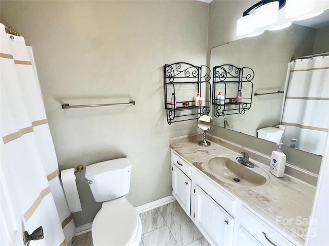 full bathroom featuring baseboards, toilet, marble finish floor, and vanity