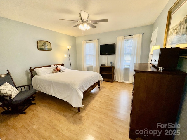 bedroom featuring light wood-style floors and ceiling fan