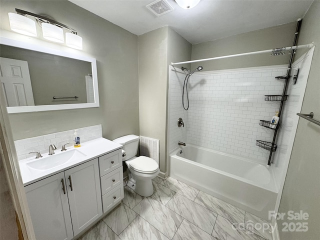 bathroom featuring vanity, visible vents, marble finish floor, toilet, and tasteful backsplash