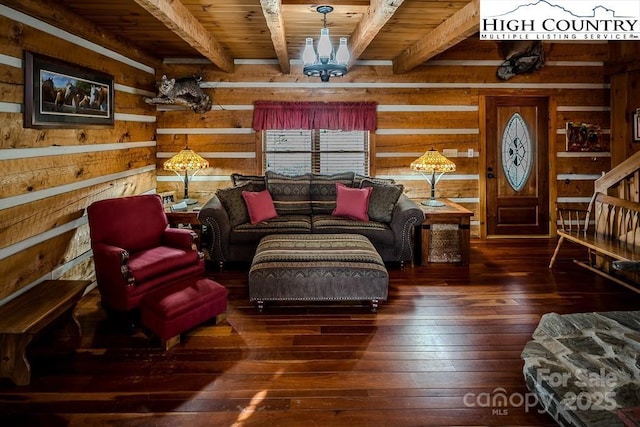 sitting room with dark hardwood / wood-style floors, a notable chandelier, wood ceiling, and wood walls