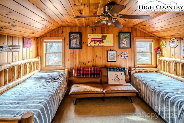 carpeted bedroom featuring vaulted ceiling, wooden walls, and wood ceiling