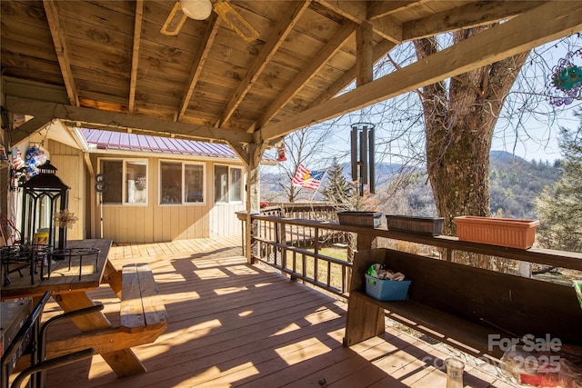 wooden deck featuring ceiling fan and a mountain view