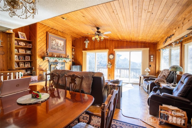 dining space featuring wooden ceiling, vaulted ceiling, and wood walls