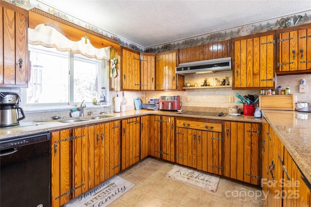 kitchen with sink, backsplash, light stone counters, black appliances, and a textured ceiling