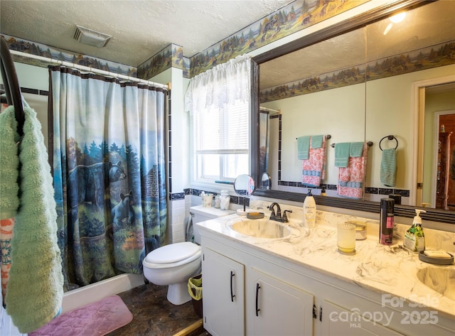 bathroom with vanity, a shower with curtain, toilet, and a textured ceiling