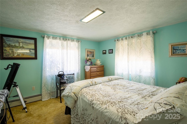 carpeted bedroom featuring crown molding, a baseboard heating unit, and a textured ceiling