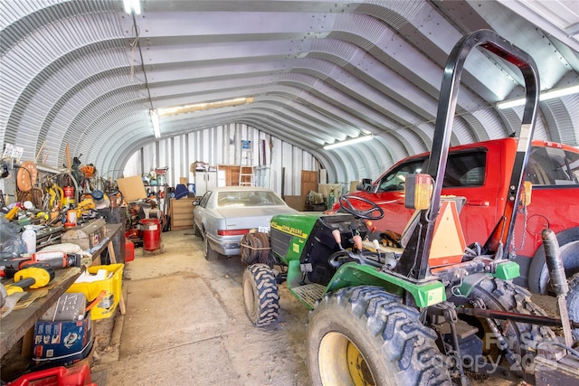 miscellaneous room with vaulted ceiling and concrete floors