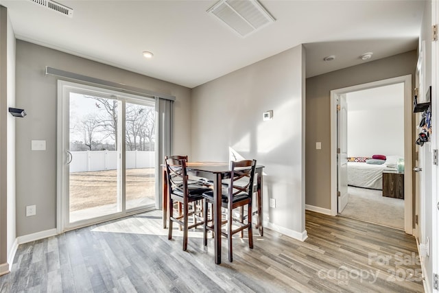 dining space featuring light wood-type flooring