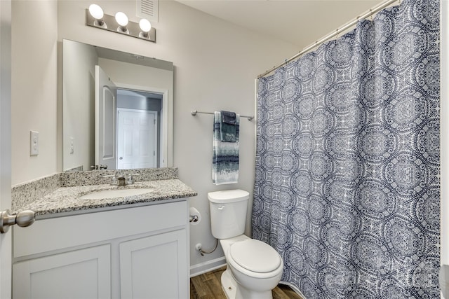 bathroom with vanity, hardwood / wood-style floors, and toilet