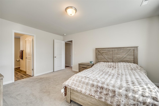 bedroom with ensuite bathroom and carpet