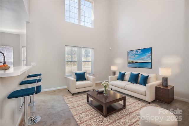 carpeted living room with a high ceiling