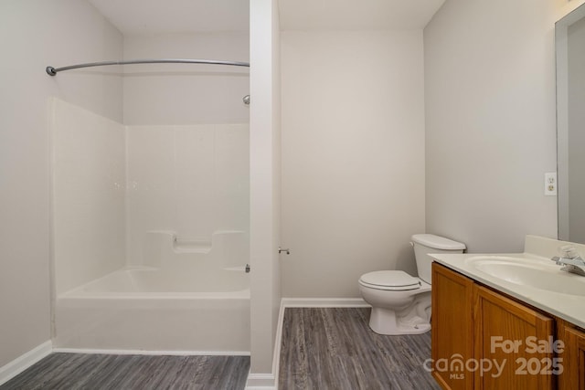 full bathroom featuring shower / bath combination, vanity, hardwood / wood-style floors, and toilet