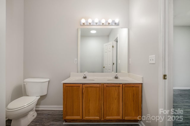 bathroom featuring vanity, hardwood / wood-style floors, and toilet