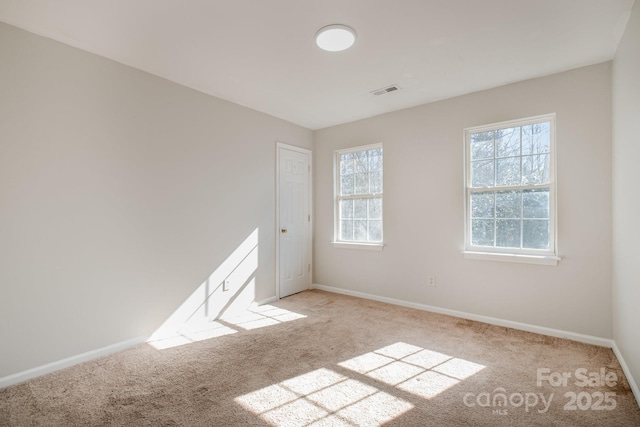 empty room featuring light carpet