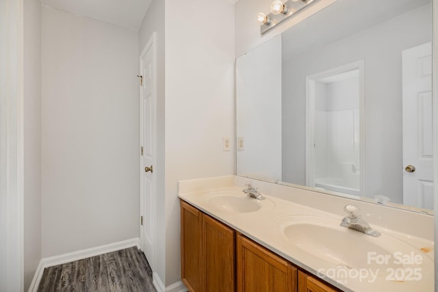 bathroom featuring walk in shower, vanity, and hardwood / wood-style floors