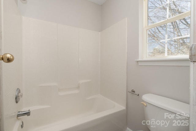 bathroom with shower / washtub combination and toilet