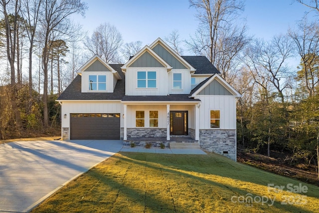 view of front of house featuring a garage and a front lawn