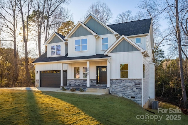 craftsman-style home with a garage, a porch, central AC, and a front lawn