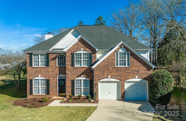 view of front of property featuring a garage and a front lawn