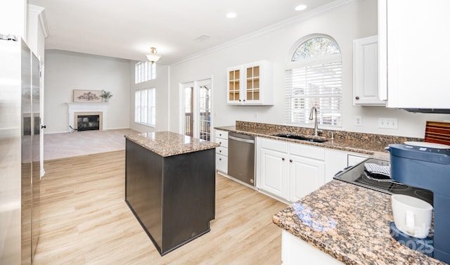 kitchen with stone countertops, sink, white cabinets, a center island, and stainless steel appliances