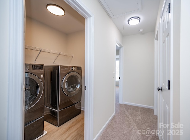 clothes washing area featuring washing machine and dryer and light carpet