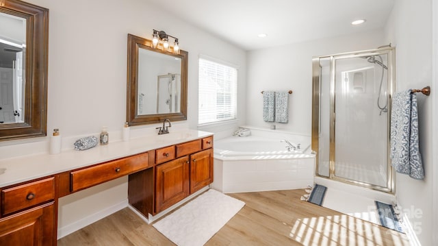 bathroom featuring vanity, shower with separate bathtub, and wood-type flooring