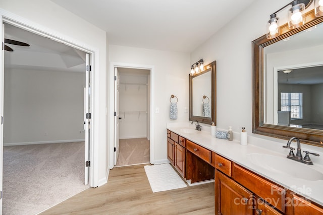 bathroom featuring hardwood / wood-style flooring, ceiling fan, and vanity